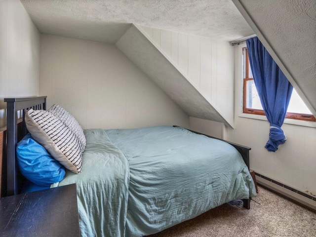 carpeted bedroom with a textured ceiling and baseboard heating