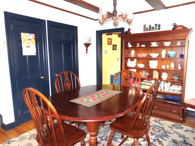 dining space featuring a notable chandelier and light wood-type flooring