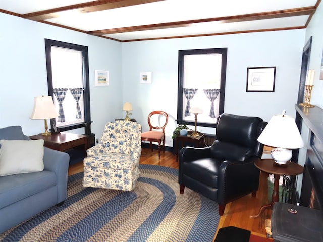 living room with hardwood / wood-style floors and ornamental molding