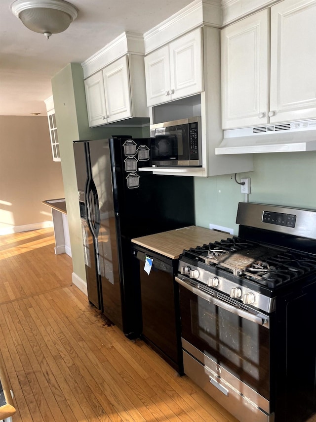 kitchen featuring white cabinetry, appliances with stainless steel finishes, and light wood-type flooring