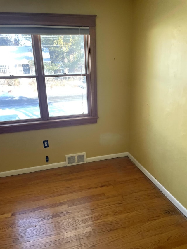 empty room with hardwood / wood-style floors