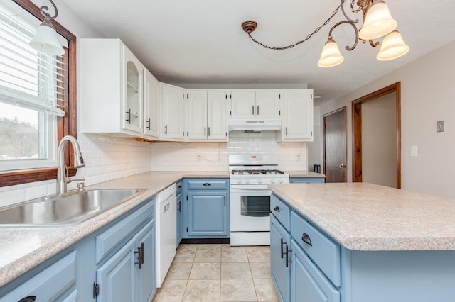 kitchen featuring sink, white appliances, white cabinetry, blue cabinets, and decorative light fixtures