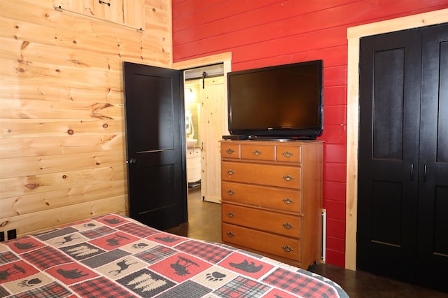 bedroom featuring wooden walls