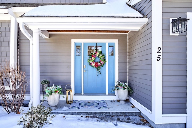 view of snow covered property entrance