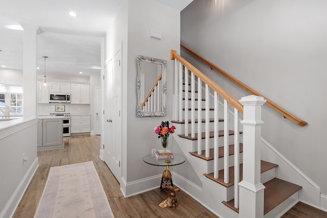 stairs with hardwood / wood-style floors