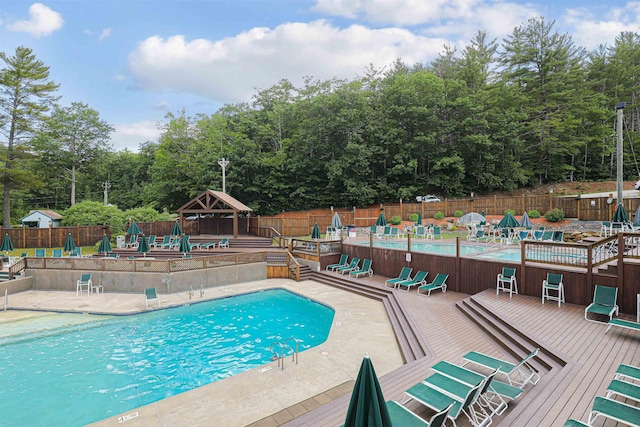 view of pool with a gazebo and a wooden deck