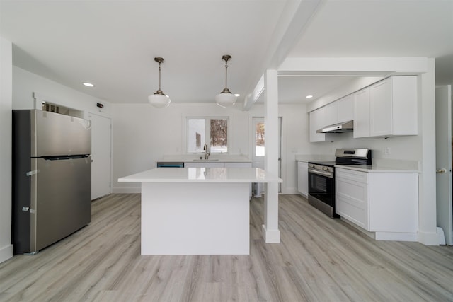 kitchen featuring appliances with stainless steel finishes, pendant lighting, white cabinetry, sink, and a center island