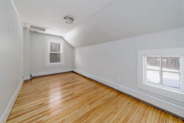 bonus room featuring a healthy amount of sunlight, lofted ceiling, and light hardwood / wood-style floors