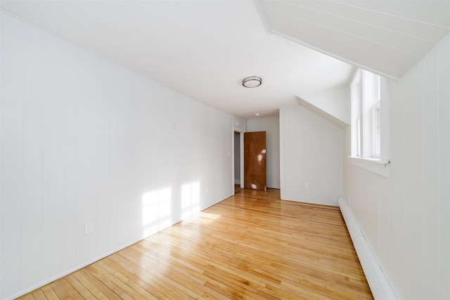 bonus room featuring baseboard heating and light hardwood / wood-style flooring