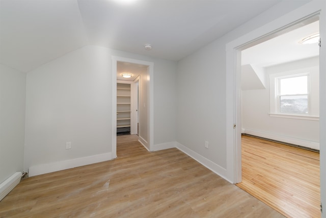 bonus room with lofted ceiling, light hardwood / wood-style flooring, and baseboard heating