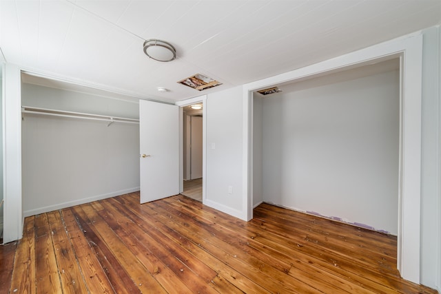 unfurnished bedroom with wood-type flooring and a closet