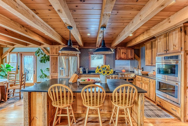 kitchen featuring beamed ceiling, wood ceiling, appliances with stainless steel finishes, pendant lighting, and light hardwood / wood-style floors