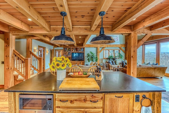 kitchen featuring pendant lighting, wood ceiling, beam ceiling, and light hardwood / wood-style floors