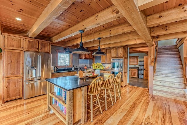 kitchen featuring pendant lighting, sink, light hardwood / wood-style floors, stainless steel appliances, and wooden ceiling