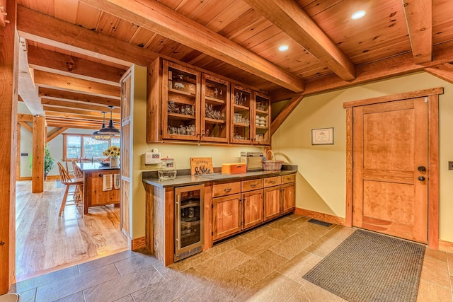 kitchen with beamed ceiling, wood ceiling, beverage cooler, and hanging light fixtures