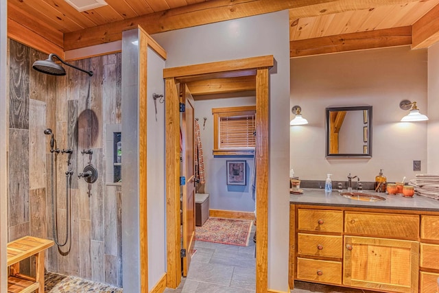 bathroom with wood ceiling, beamed ceiling, vanity, and a tile shower