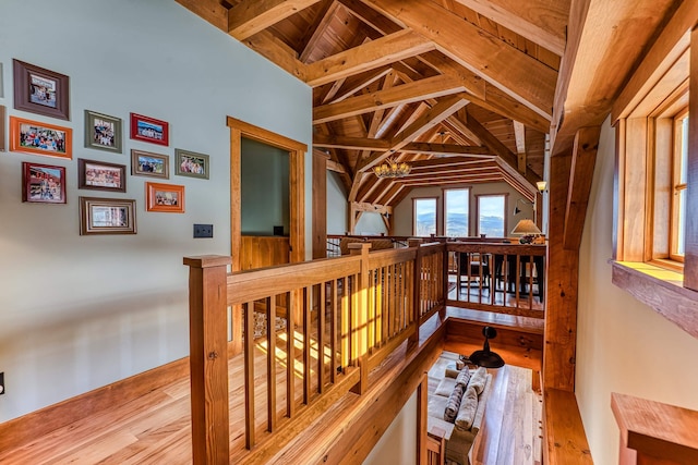 hall featuring vaulted ceiling and light hardwood / wood-style flooring