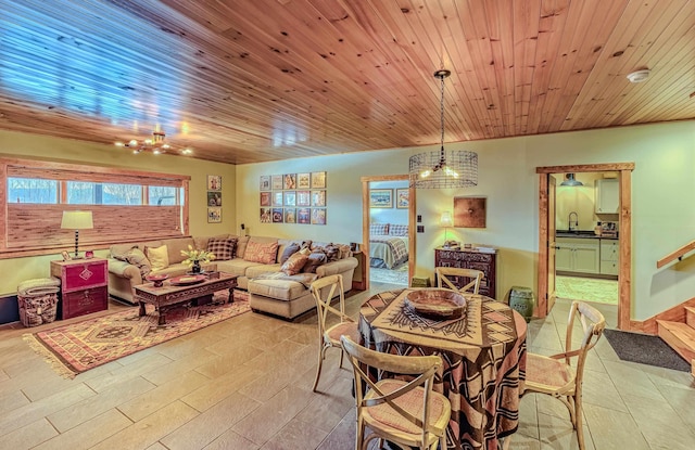 dining space featuring sink and wood ceiling