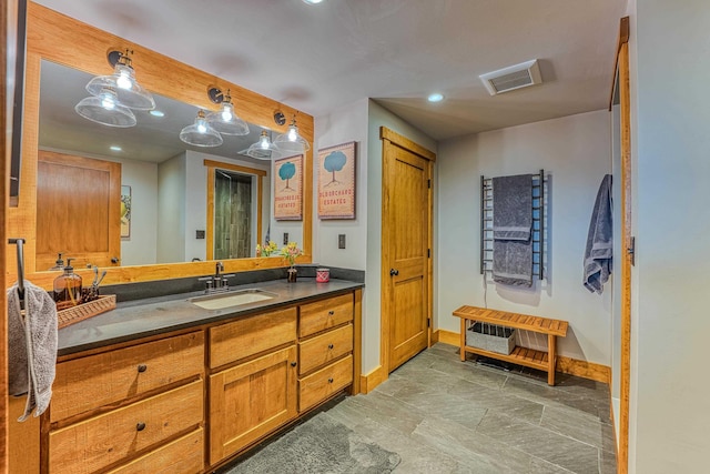 bathroom with vanity and beam ceiling