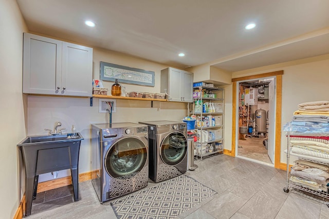 washroom with cabinets and washing machine and dryer