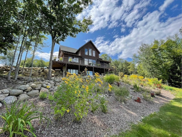 rear view of property featuring a wooden deck