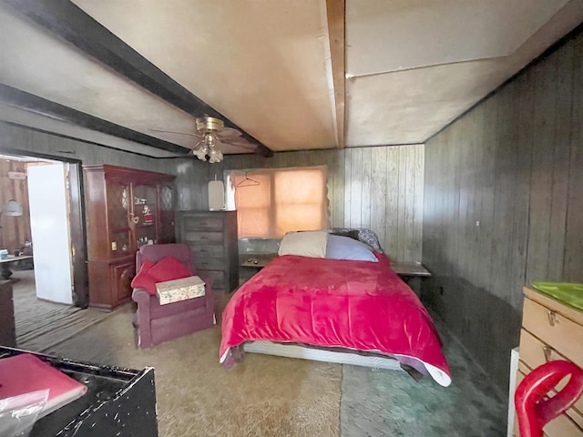 bedroom featuring wooden walls and beam ceiling