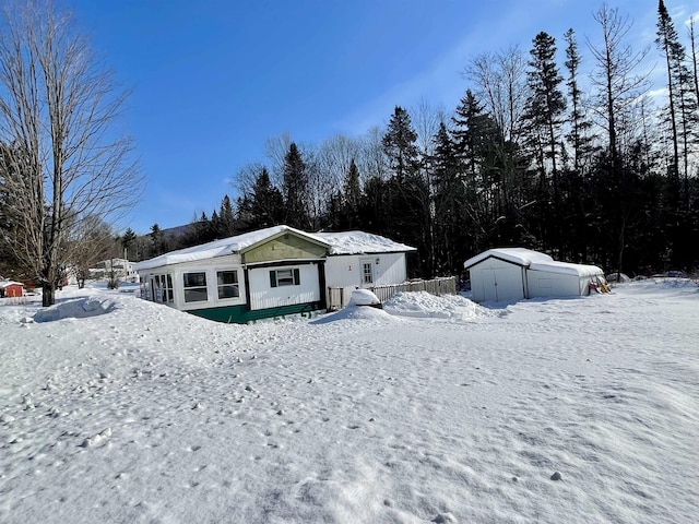 view of front of home with a shed