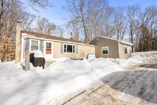 view of snow covered rear of property