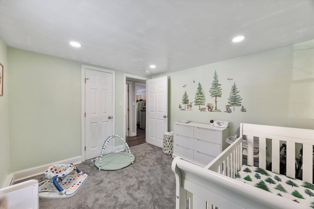 carpeted bedroom with a nursery area