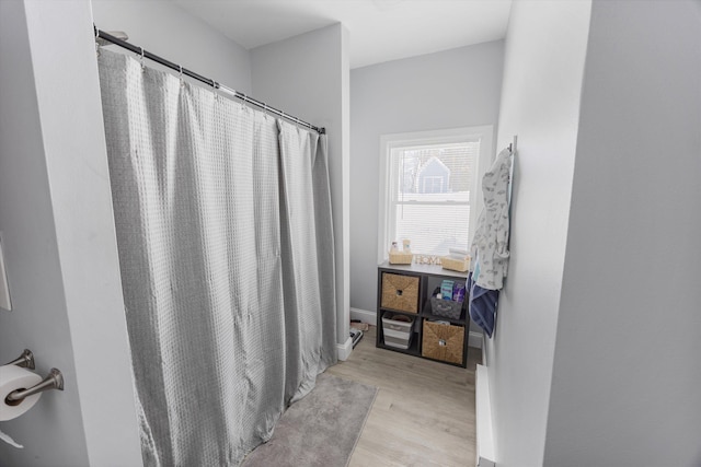 bathroom featuring hardwood / wood-style floors and curtained shower