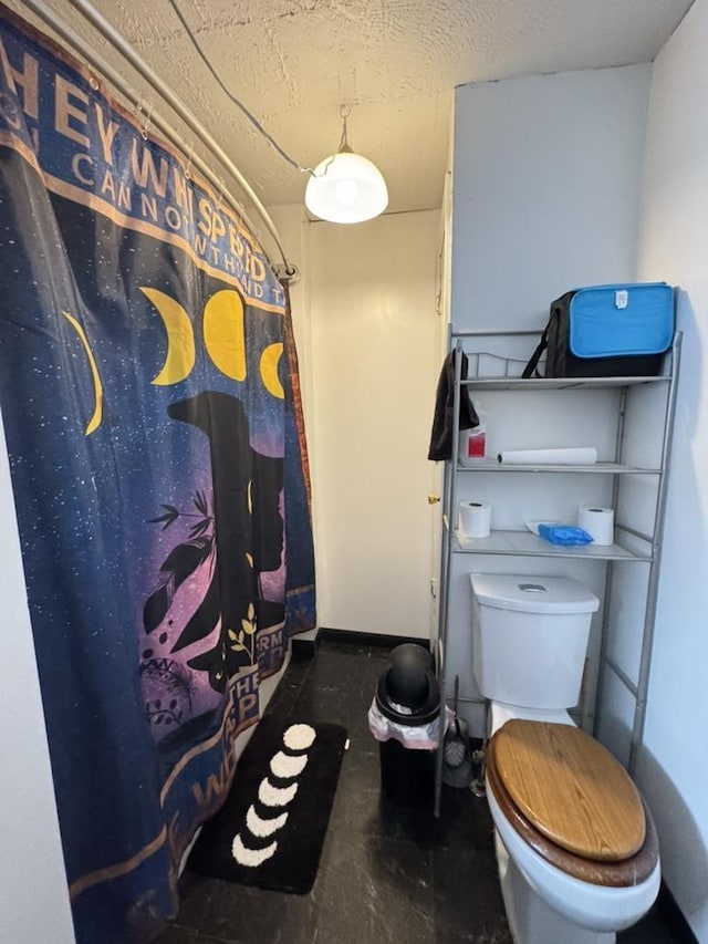 bathroom featuring toilet and a textured ceiling