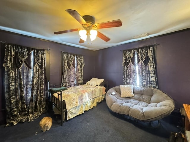 bedroom with crown molding, carpet, and ceiling fan