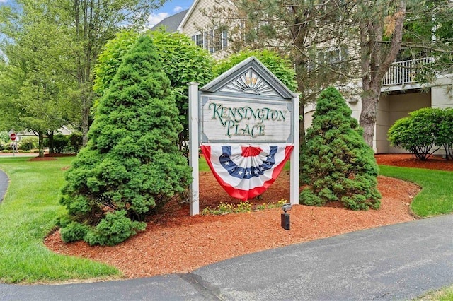 community sign featuring a lawn