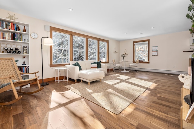 sitting room featuring hardwood / wood-style flooring and a baseboard heating unit