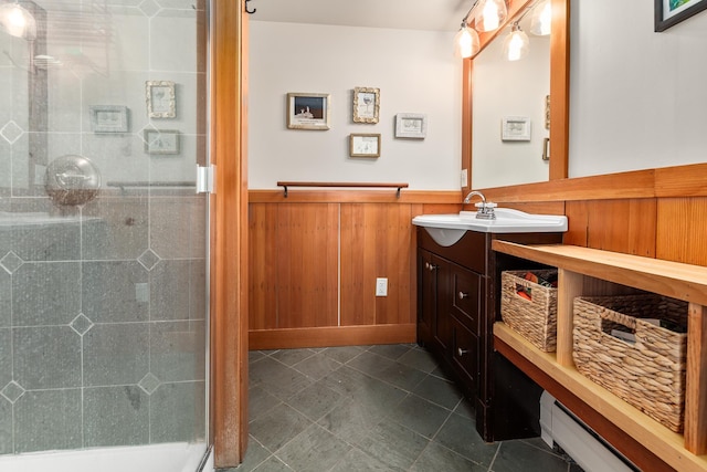 bathroom with vanity, baseboard heating, and walk in shower