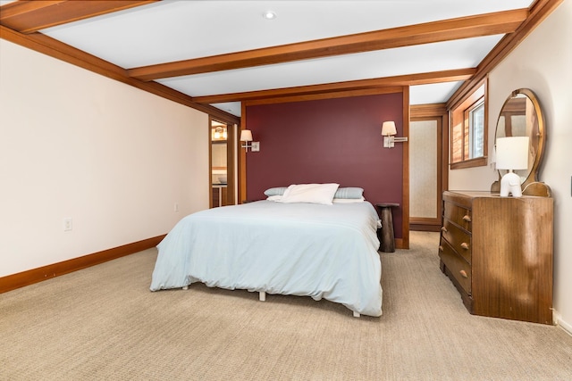 carpeted bedroom with beam ceiling