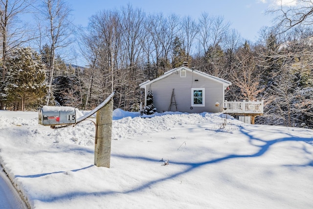 yard covered in snow with a deck