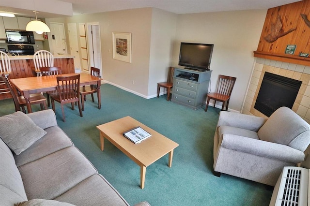 carpeted living room with a tile fireplace