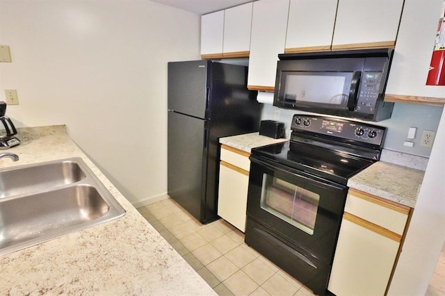 kitchen featuring white cabinetry, light tile patterned floors, sink, and black appliances