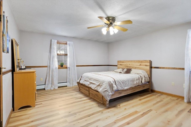 bedroom featuring a baseboard radiator, a textured ceiling, and light wood-type flooring