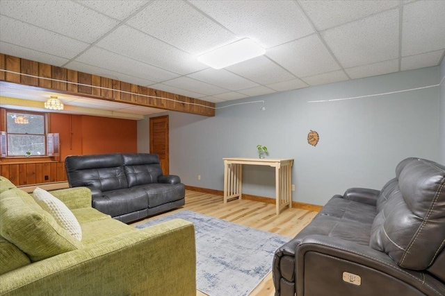 living room with hardwood / wood-style flooring and a drop ceiling