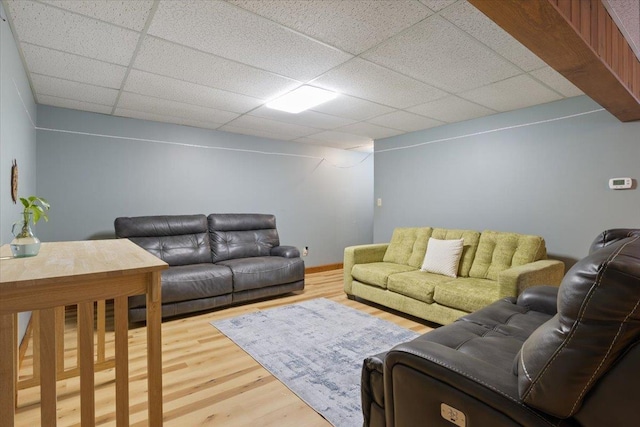 living room with hardwood / wood-style floors and a paneled ceiling