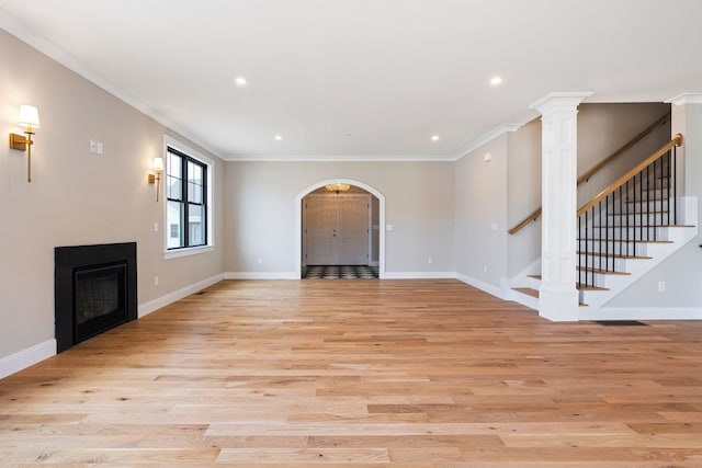 unfurnished living room with crown molding and light hardwood / wood-style flooring