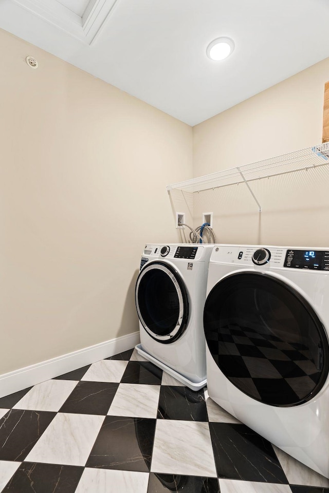 clothes washing area with washer and clothes dryer