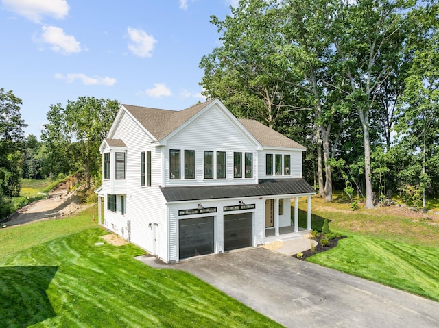 view of front of home featuring a garage, a front lawn, and a porch