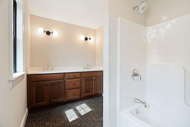 bathroom with vanity and shower / washtub combination