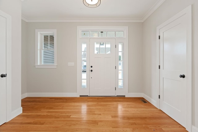 entrance foyer featuring crown molding and light hardwood / wood-style floors