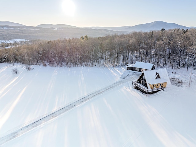 snowy aerial view featuring a mountain view