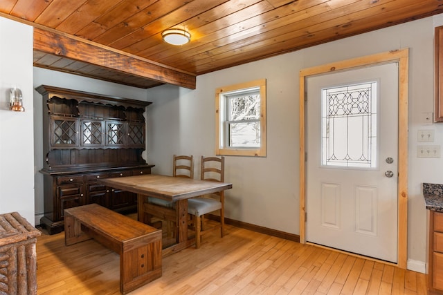 dining area with beam ceiling, wooden ceiling, and light wood-type flooring