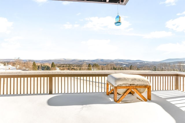 wooden deck with a mountain view